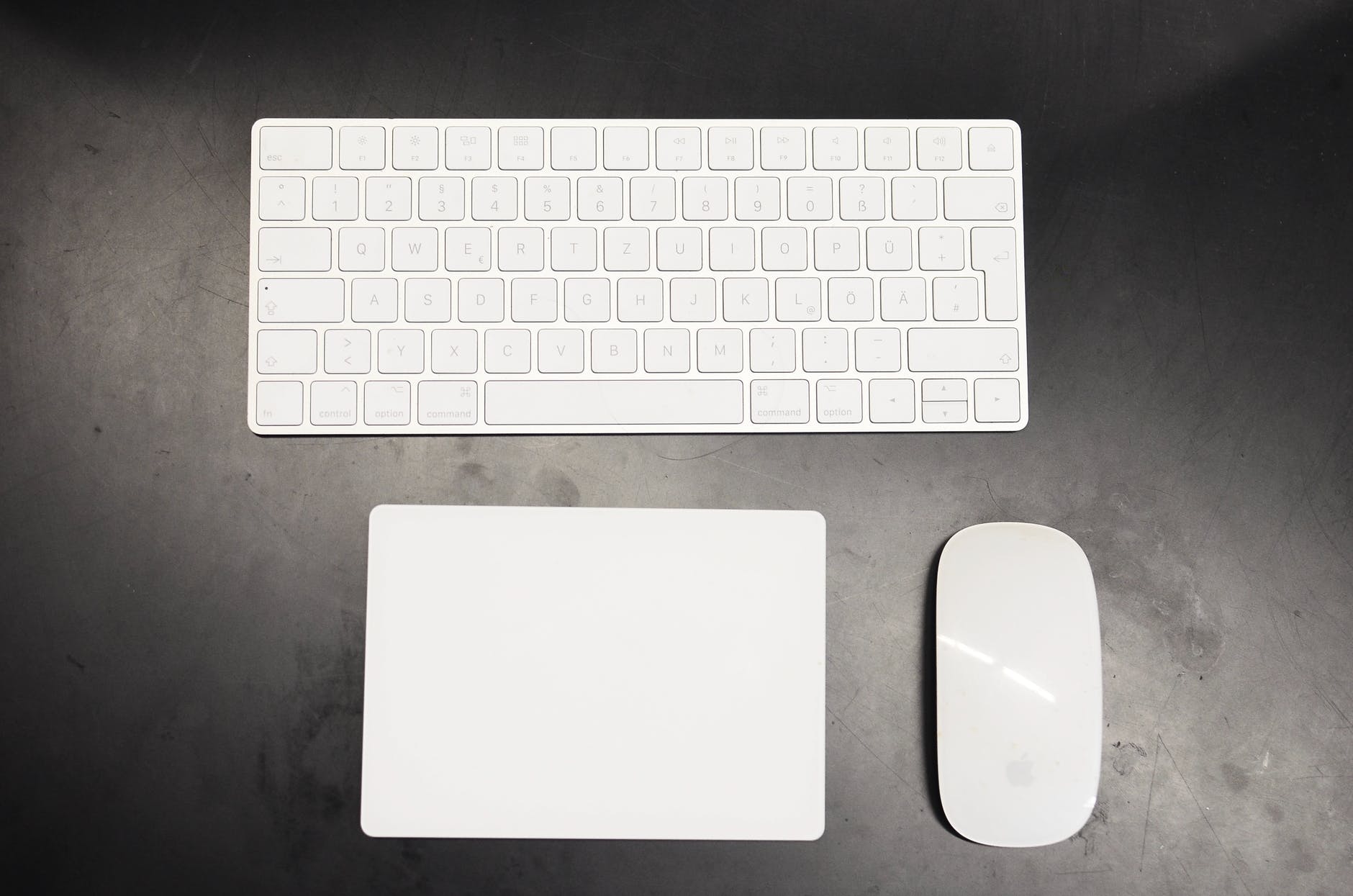 white keyboard and mouse placed on black table